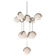 a chandelier with five lights hanging from it's sides and four balls on each end