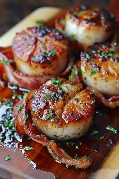 there are some scallops on a cutting board with bacon and parsley sprinkled around them