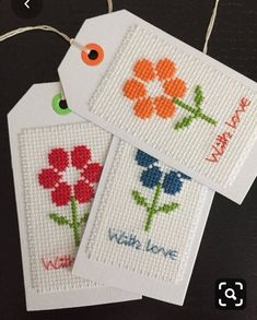 cross stitch tags with flowers on them