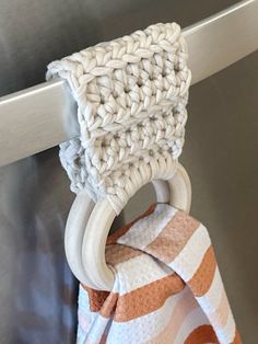 an orange and white towel hanging from a hook