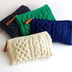 four different colored knitted items sitting next to each other