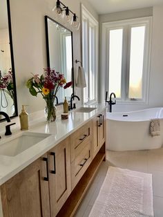 a large bathroom with two sinks and a bathtub