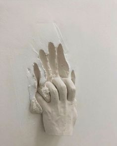 a plaster hand on a white wall