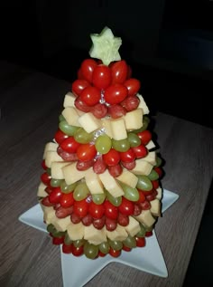 a christmas tree made out of cheese and grapes