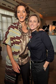 two women standing next to each other smiling