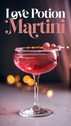 a pink cocktail sitting on top of a table