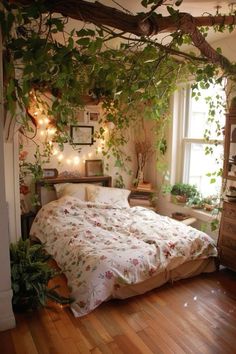 a bed sitting in a bedroom next to a window covered in vines and plants with lights on either side of the bed