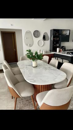 a dining room table with chairs around it