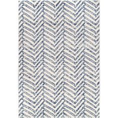 a rug with blue and white chevroned lines on it, in the shape of a zigzag pattern