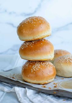 three sesame bagels stacked on top of each other