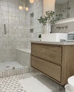 a bathroom with a sink, toilet and bathtub next to a walk in shower