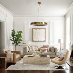 a living room filled with furniture and a painting on the wall above it's fireplace