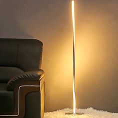 a lamp that is on the floor next to a chair