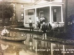 an old black and white photo of people in a boat