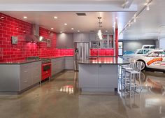 a modern kitchen with red and gray accents