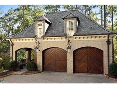 a two car garage with three doors and windows