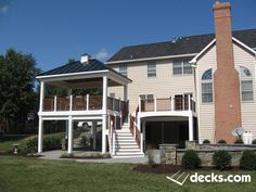 a two story house with stairs leading to the second floor