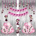 minnie mouse birthday decorations with pink balloons and streamers hanging from the ceiling in front of a curtain