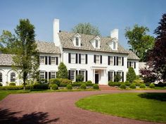 a large white house with black shutters on the windows