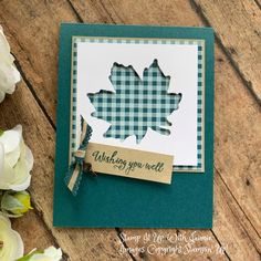 a close up of a card on a table with flowers