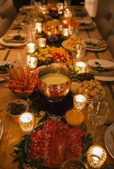 the table is set for thanksgiving dinner with pumpkins