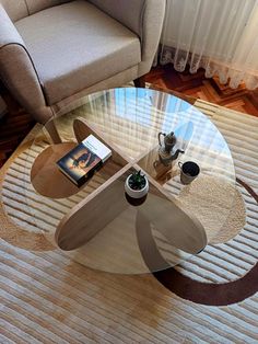 a glass table sitting on top of a wooden floor