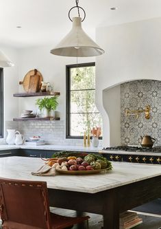 a kitchen with an island, stove and sink