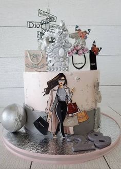 a birthday cake decorated with an image of a woman carrying shopping bags and purses