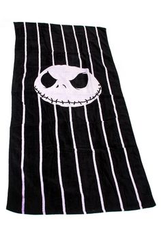 a black towel with a white jack skellingy face on the front and stripes around it