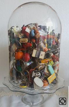 a glass bowl filled with lots of assorted items