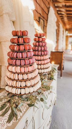 two stacks of macaroons sitting on top of a table