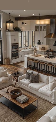 a living room filled with white furniture and lots of windows