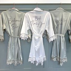 three bridesmaid robes are hung on the wall with their name written on them