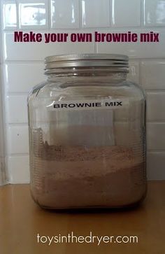 a brownie mix in a glass jar on top of a counter with the words make your own brownie mix