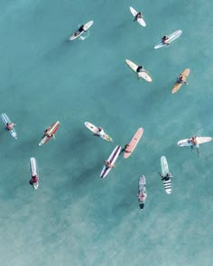 an aerial view of several surfboards in the water