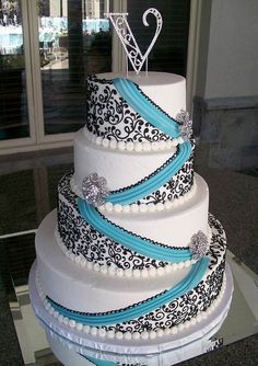 a wedding cake with blue ribbon and white frosting on the top is displayed in an instagram