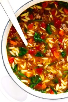 a white bowl filled with pasta and meat soup