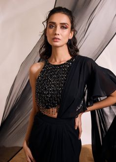 Make a bold statement with hailey sari set, a fusion of modern sophistication and traditional charm. The ensemble includes a heavily embellished backless blouse with elegant tassel accents, paired with a concept drape sari for an enchanting and distinct look. Designer Black Draped Saree, Black Georgette Draped Saree, Black Draped Georgette Saree, Black Draped Saree With Sheer Dupatta, Black Bollywood Style Pre-draped Saree, Black Bollywood Pre-draped Saree, Party Wear Draped Choli With Unstitched Blouse, Black Pre-draped Saree With Sequins, Party Choli With Unstitched Draped Blouse