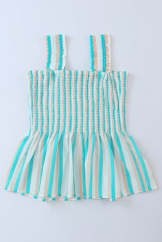 This Aqua Tan Striped Smocked Peplum Tank Top is a summertime staple that's sure to make a splash. Featuring a stylish ruffle strap and smocked bodice, this top will keep you looking stylish and feeling cool all season long. Who said stripes have to be boring. #stripeslikethese Peplum smocked wide strap tank top in aqua, tan and white colors. Fun top for summer with its beach colors and comfy smocked top, has wider straps so it can be worn with a bra without it showing. Roomy fit in waist and sm Chic Summer Smocked Dress With Elastic Shoulders, Summer Smocked Dress With Elastic Shoulders, Casual Cotton Smocked Top With Ruffled Straps, Casual Smocked Top With Smocked Bodice For Summer, Casual Smocked Bodice Top For Summer, Cotton Smocked Top With Ruffled Straps, Cotton Smocked Top With Ruffles For Vacation, Smocked Top With Ruffled Straps For A Day Out, Summer Smocked Top With Ruffles