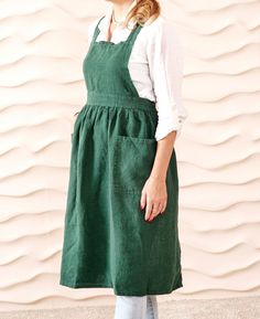 Discover the perfect blend of style and functionality with our linen pinafore apron dress for women. This linen apron dress features handy pockets, making it ideal for gardening, cooking, or everyday wear.  PRODUCT SPECIFICATION Length - 32" / 82 cm Width - 31" / 80 cm Chest width - 10" / 25 cm Model is 5 feet 5"/165 cm, size S 100% stone washed organic linen - 260 GSM 2 front pockets OEKO-TEX Standard 100 certified fabric Fits XS - XXL sizes (Unisex) Adjustable ties Cotton Apron With Pockets, Green Linen Dress With Pockets, Sleeveless Linen Pinafore Dress With Pockets, Sleeveless Linen Pinafore Dress, Summer Linen Pinafore Dress, Pinafore Apron Dress, Linen Pinafore Dress, Linen Pinafore Apron, Linen Apron Dress