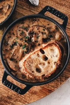 a skillet filled with food on top of a wooden table