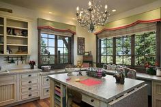 a large kitchen with an island in the middle and lots of cabinets on both sides