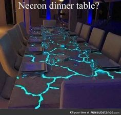 a long table is lit up with glowing blue lights and the words custom dinner table on it