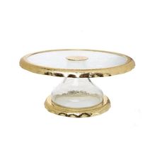 a gold plate with a glass lid on it's side and a white background