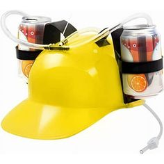 a yellow hard hat with soda cans attached to the front and sides, as well as an orange juice can