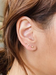 a close up of a person wearing ear piercings