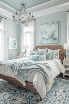 a bedroom with a bed, chandelier and rugs on the floor in front of two windows