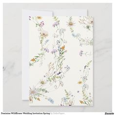 a white card with flowers on it and the words, floral wedding stationery spring