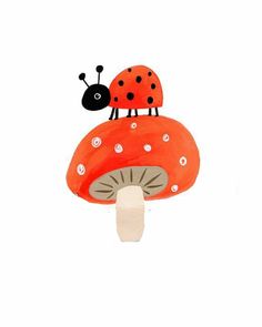 an orange mushroom with a ladybug on it's top and white dots