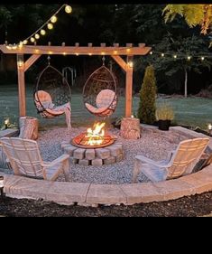 a fire pit with chairs and lights around it